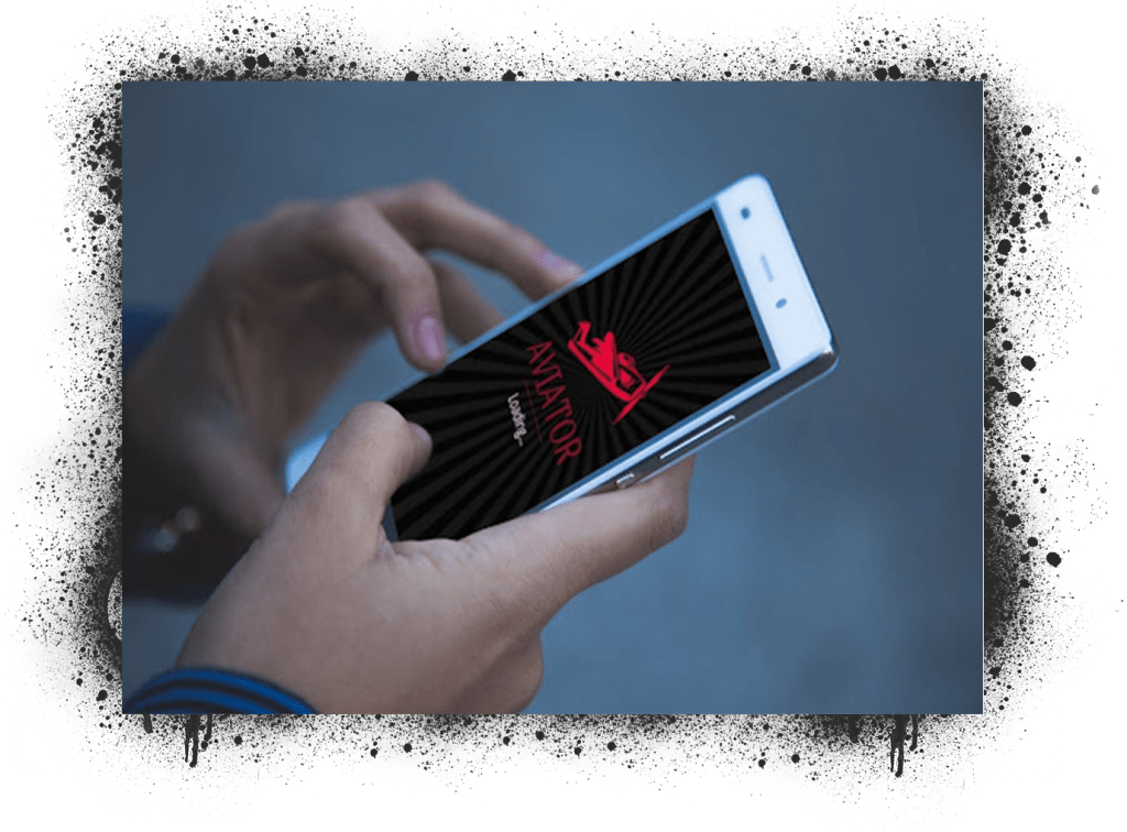 Uma mão segurando um smartphone exibindo o processo de carregamento do jogo Aviator